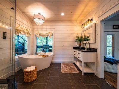 The private bathroom features a soaking tub and walk-in shower.