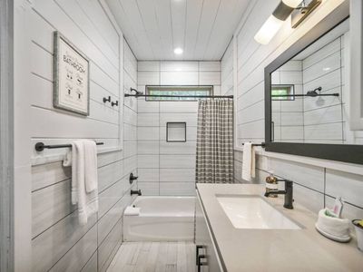 The private bunk bathroom has a tub and shower.