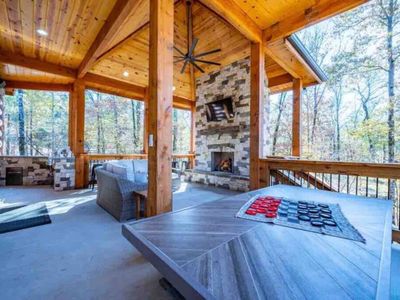 The upper level of the patio has sofas, a grill, checkers and more!