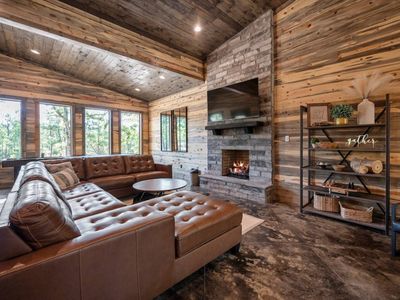 An oversized sectional around the gas fireplace.