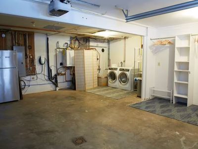 Enter into the laundry room with plenty of storage for all shoes and coats