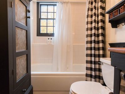 Checkered accents make this bathroom charming.