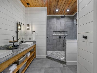 The private bath has an oversized walk-in shower and double vanity.