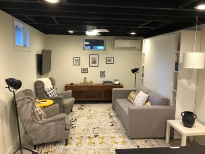 Cozy downstairs living area with Queen sized Murphy bed and smart TV.