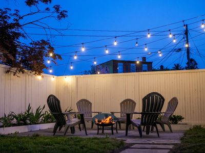 Unwind at night on the bluestone patio, perfect for bonfires under the lights in the heart of Kingston