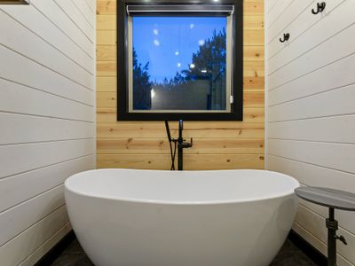 This oversized soaking tub plus a side table for all of the relaxation.