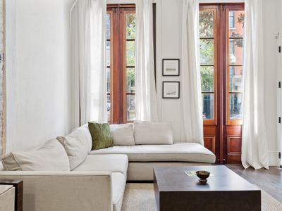 Beautiful sunny living room space equipped with all you need