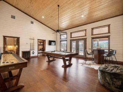 Open game room-Featuring pool table, shuffle board, pub table, and 50 inch TV