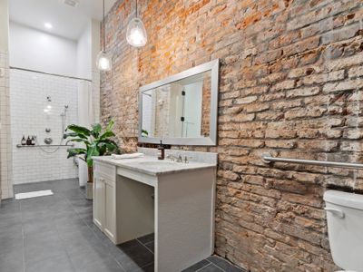 Historic brick walls in the huge bathroom