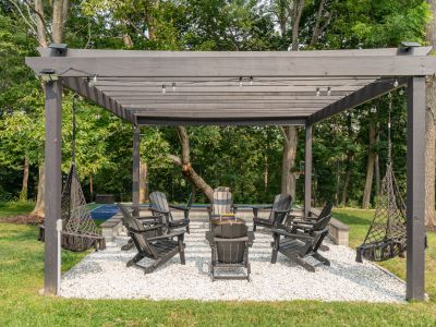 Whether in an Adirondack chair or hammock swing, you'll love sitting by the fire pit.