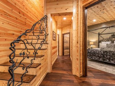 The staircase to the second floor features an intricate hand rail.