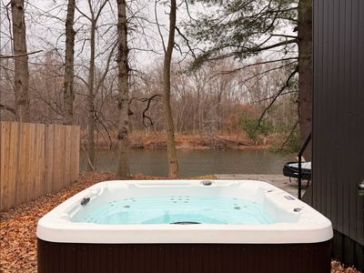 Enjoy the hot tub with river views, just steps off the back porch.