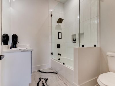 Luxe master bathroom with glass enclosure and rainfall shower head. (Bathroom 1.5/3.5)