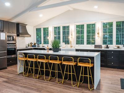 Waterfall countertops and gold accents in the kitchen