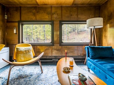 The office, equipped with a writing desk and additional seating.