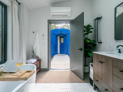 The Bathhouse is located in a separate structure outside of train car, with separate entrance.