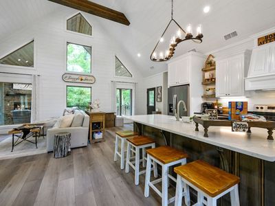 The kitchen area has 4 seats at the bar top!