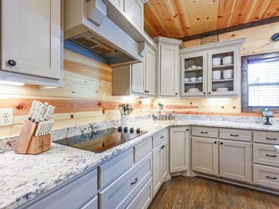 The white cabinets and stone countertops add brightness to the home.