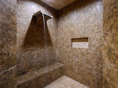 Huge walk in shower with waterfall head.