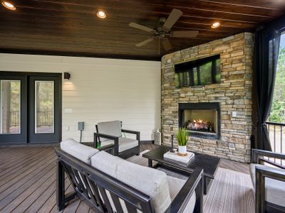 A couch and chairs surround the fireplace on the covered deck!