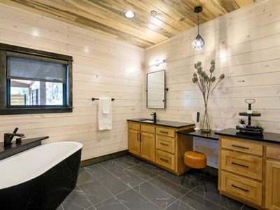 Private full bath with oversized soaking tub to unwind in.