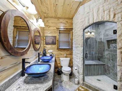 In-suite bathroom with double sink and walk-in shower.