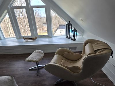 NOUHAUS Heated Classic Massage Chair is a welcome addition to the attic space. This full-body and spot massaging recliner comes with an ottoman, Bluetooth speaker, and in-chair charger, and also functions as a portable Shiatsu body massager.