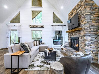 The living room with a floor to ceiling fireplace and Queen sofa sleeper.