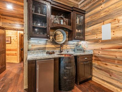 A whiskey barrel wet bar in the game room.