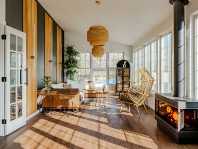 Step inside the home and be greeted by this warm, light-filled sun room. Please know the fireplace is currently non-operational!