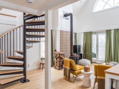 Spiral stairs leading to the loft add to the architectural charm.