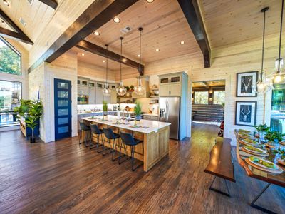 Come together in the open living/kitchen/dining space where gourmet style meets rustic warmth—every moment feels effortless here.