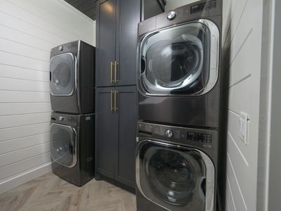 Spacious laundry room with 2 washers and dryers.