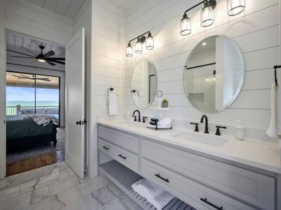 Attached private bathroom with double vanity.