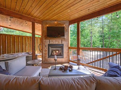 The bottom covered patio features an oversized outdoor sectional + fireplace.