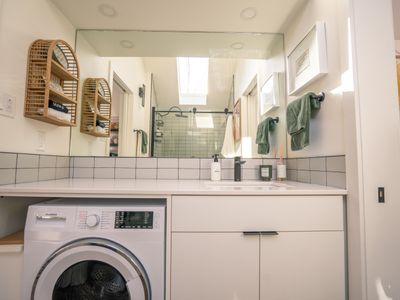 Plenty of counter space over the washer/dryer in the bathroom