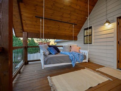 A swinging daybed on the private balcony.