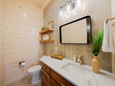 Conveniently located just off the game room, this stylish half bath keeps everyone comfortable and refreshed throughout the day—no trips upstairs required.