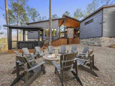 The fire pit complete with Adirondack chairs.
