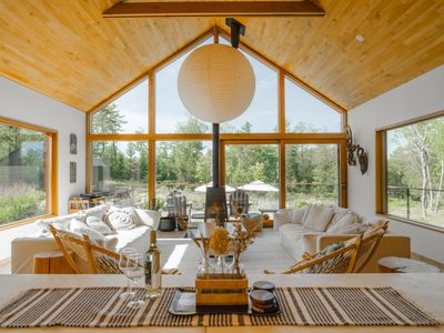 the open concept kitchen and beautiful main living room that looks out over the deck