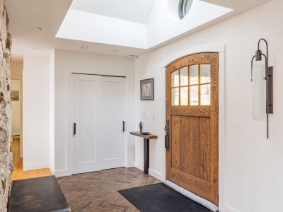 Step inside the foyer, with oversized solid wood door and skylight. The heart of the home is straight ahead, a massive fireplace covered in natural stone from the surrounding area.