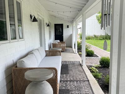A charming porch with ample seating is ideal for letting the long hours roll by.