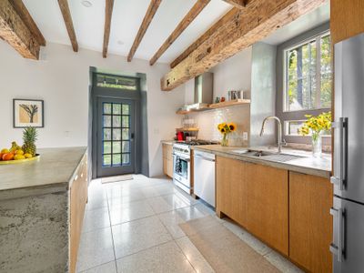 Exposed beams in the kitchen underscore the long history behind this exquisite property.