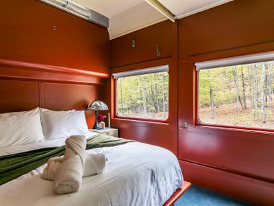 The Empire Suite equipped with a closet, bedside table, robes and slippers.