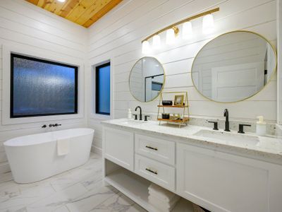 The private bath has a double vanity, walk-in shower and oversized soaking tub.