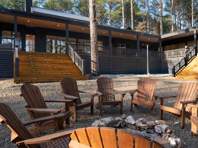 Outdoor firepit with Adirondack chairs.