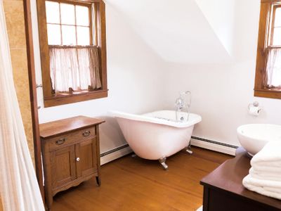 The master bathroom includes a luxurious claw foot tub and natural light.