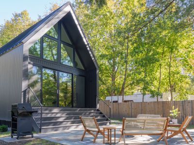 Back patio views of the property, surrounded by lines of trees.