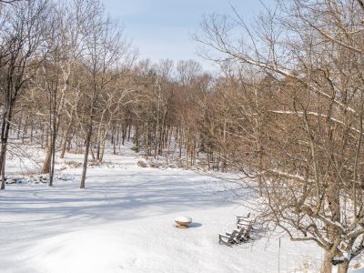 The beautiful snow filled backyard and fire pit