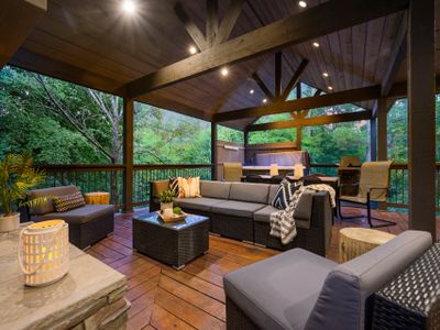 The outdoor covered patio has oversized outdoor sofas and extra lounging chairs.